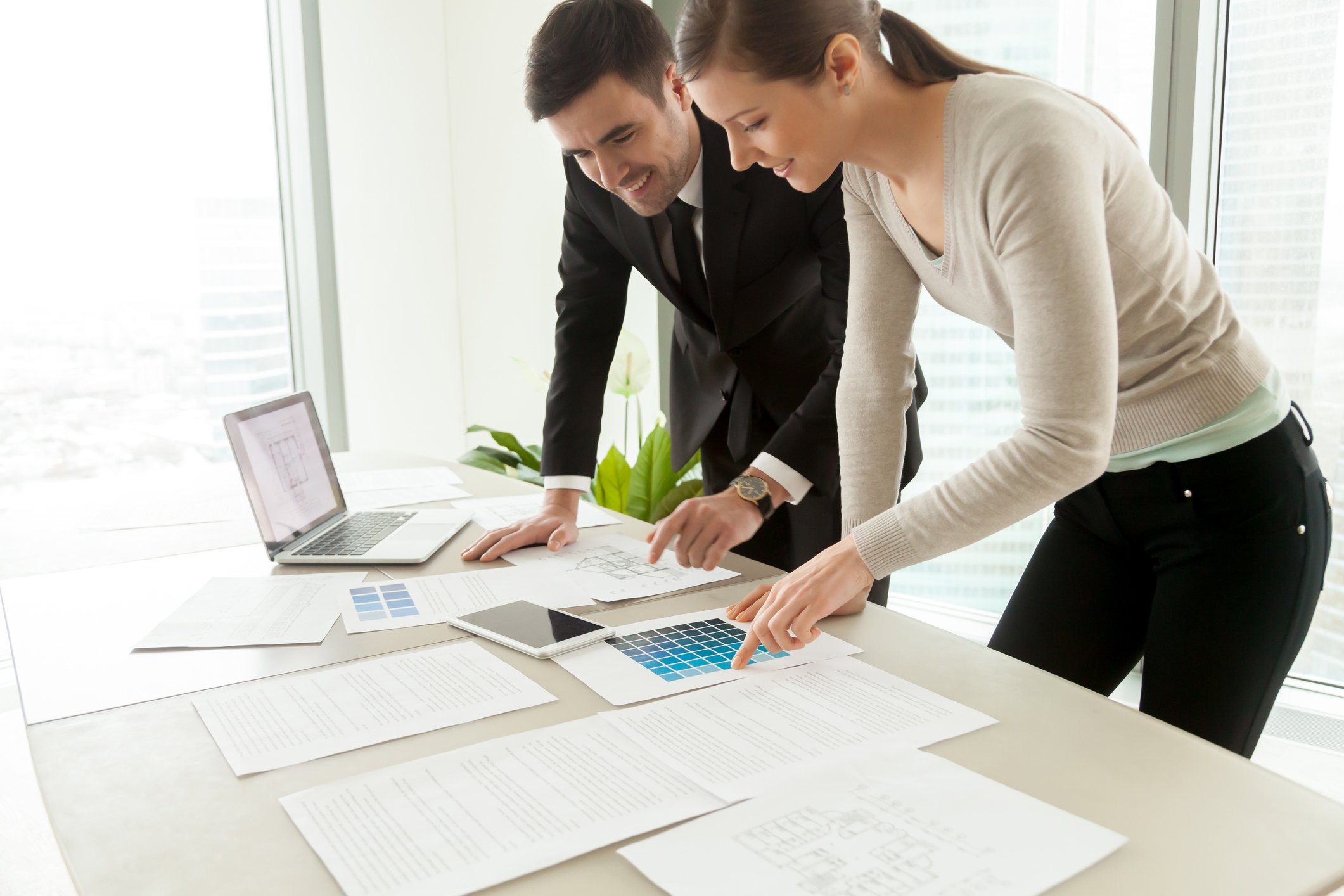 Smiling professional designers working on project, residential interior design services